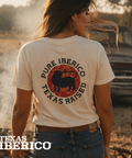 Person wearing a 'Pure Iberico Texas Raised' t-shirt in a rural setting with a truck in the background.